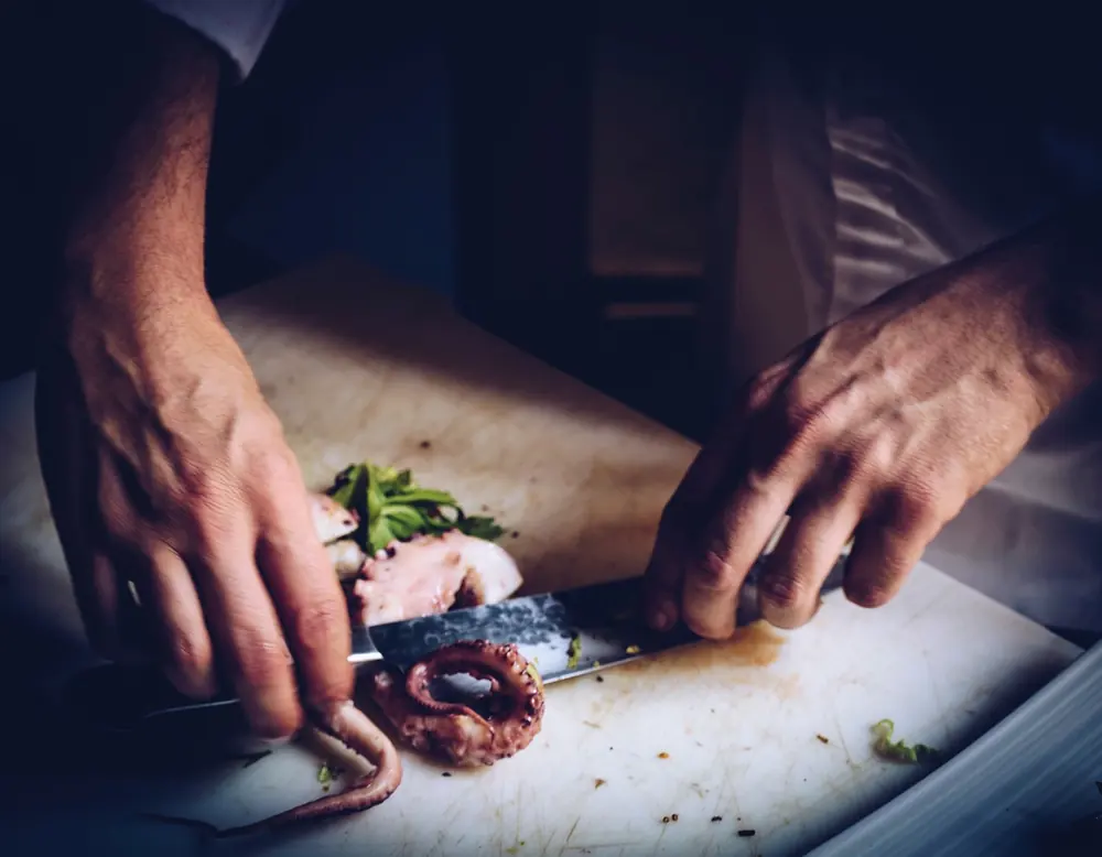 Chef preparing a dish in a professional United Kingdom restaurant kitchen